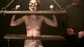 shackled redhead gags on cock in rough bondage doggy