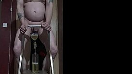 Dude climbs ladder naked to piss in bottle then chugs it all