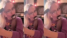 asmr blonde with glasses brushes long hair using lollipop, headphones on.