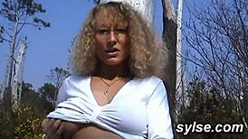 Horny milf flashes toys on beach drawing voyeurs then takes lesbian strapon pounding