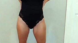 Black bodysuit clings tight over black heels in steamy try-on
