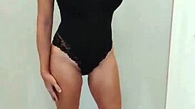 Black bodysuit clings tight over black heels in steamy try-on