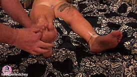 Curvy brunette milf gives barefoot footjob with toes on huge cock in bedroom