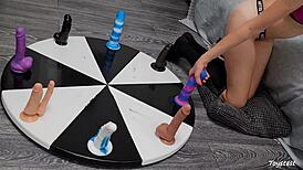 horny petite teen spins wheel of huge dildos anal toys for rough orgasm win