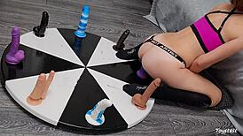 horny petite teen spins wheel of huge dildos anal toys for rough orgasm win