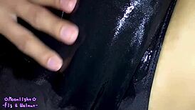trans crossdresses in navy blue swimsuit slathered slippery lotion
