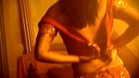 Exotic brunette milf strips sensually in oriental dance tease.