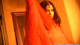 Exotic brunette milf strips sensually in oriental dance tease.