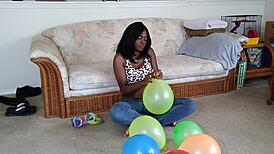 french ebony with big tits blows up balloons