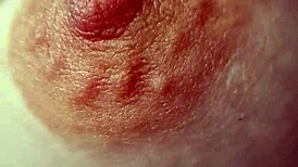 close-up view of braless amateur's hard nipples poking through thin fabric