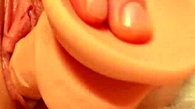 Hey watch her shove that dildo deep into her tight shaved creamy pussy close up