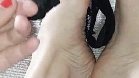 Gretala rubs thong over her sexy ebony barefoot soles