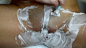 Intimate close-up of skinny brunette babe shaving her juicy wet trimmed pussy smooth