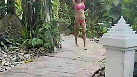 hot monika fox slips into her pink bikini, swims seductively in the pool then struts freely outdoors