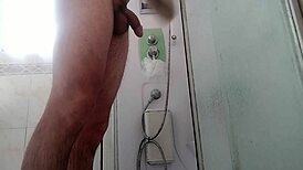 a guy showers stroking his massive monster cock teasingly