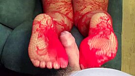 bbw milf gives a footjob while wearing red lace stockings and black panties