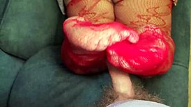 bbw milf gives a footjob while wearing red lace stockings and black panties