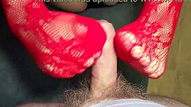 bbw milf gives a footjob while wearing red lace stockings and black panties