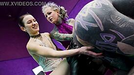 Heavy tattooed sub played with and pegged by 2 dominas