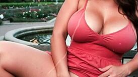 Voluptuous woman with large breasts masturbates in the park